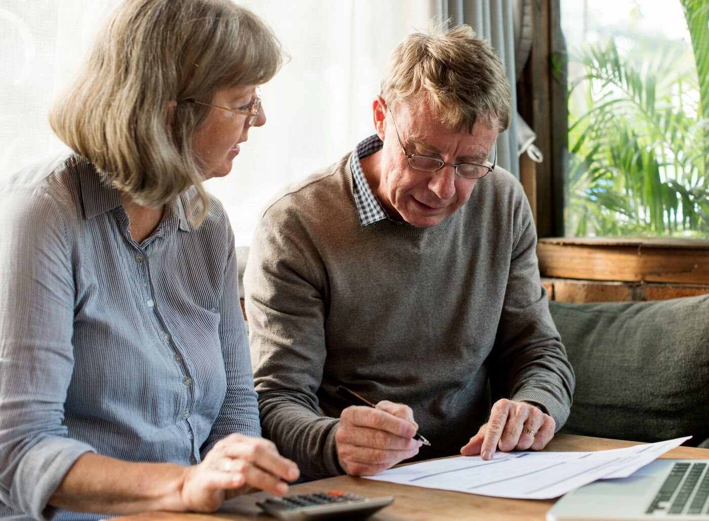 Couple reviewing financial paperwork together at a table