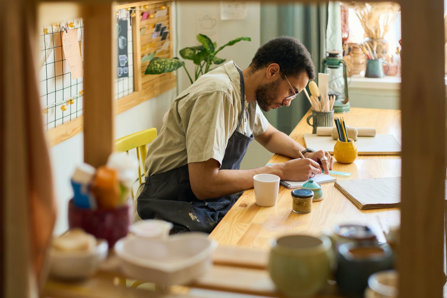 Business owner working at a table in his shop