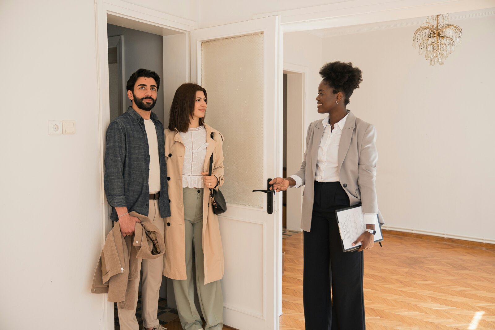 Real estate professional showing a home to two prospective occupants