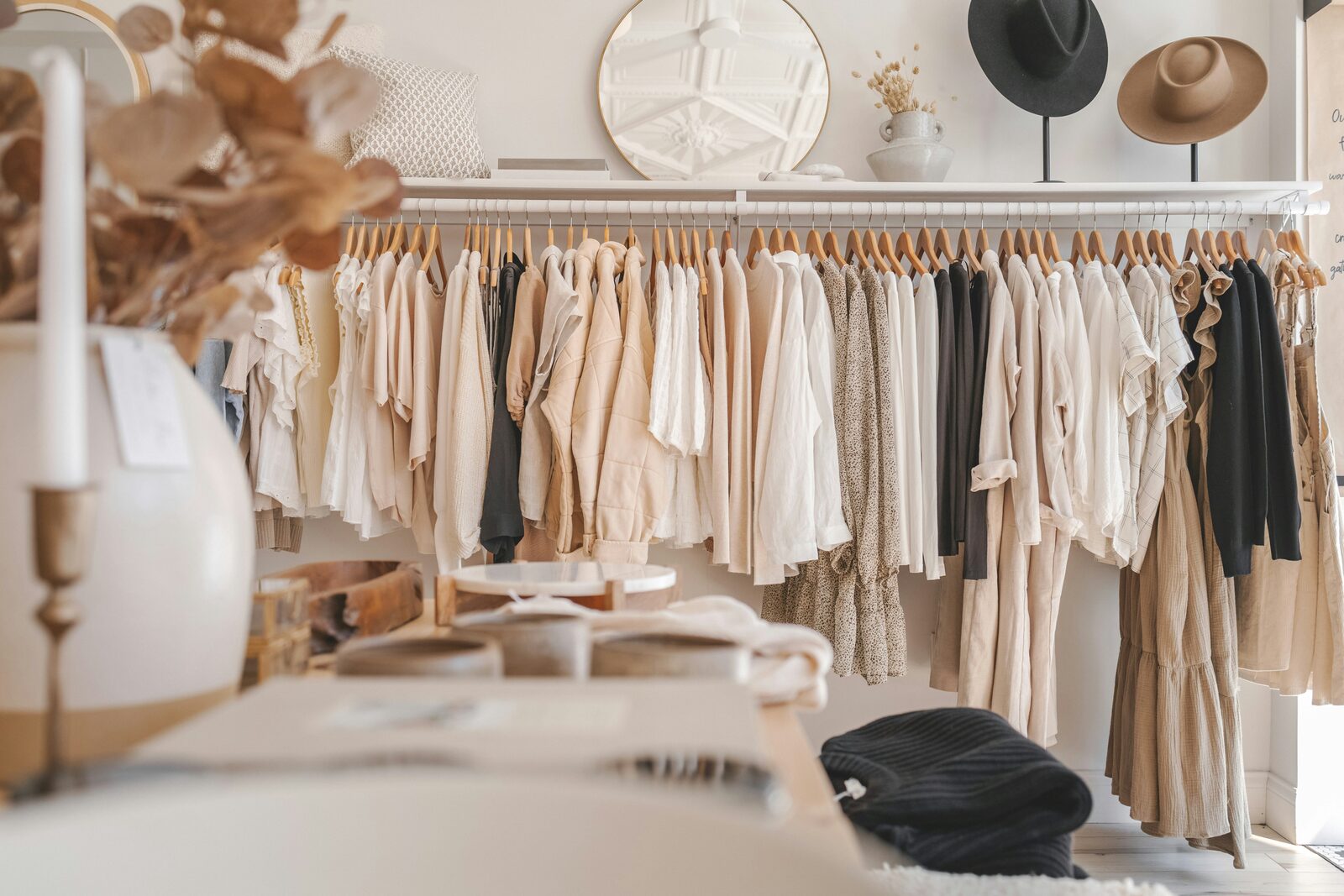 Clothing racks and accessories displayed in a bright retail boutique